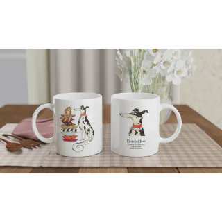 Two white mugs on a table, one with cat and spotted dog illustration and one with dog illustration and logo